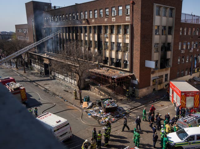 <p>Medics and emergency works at the scene of the deadly blaze in downtown Johannesburg in August </p>