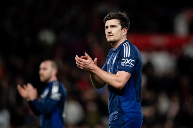 <p>Harry Maguire applauds the visiting fans after defeat to Nottingham Forest</p>