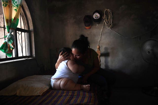 <p>Baby cuddled by mother in Mexico</p>
