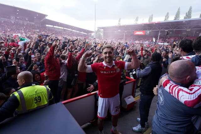 Wrexham’s Sam Smith leads the celebrations after their win (PA)