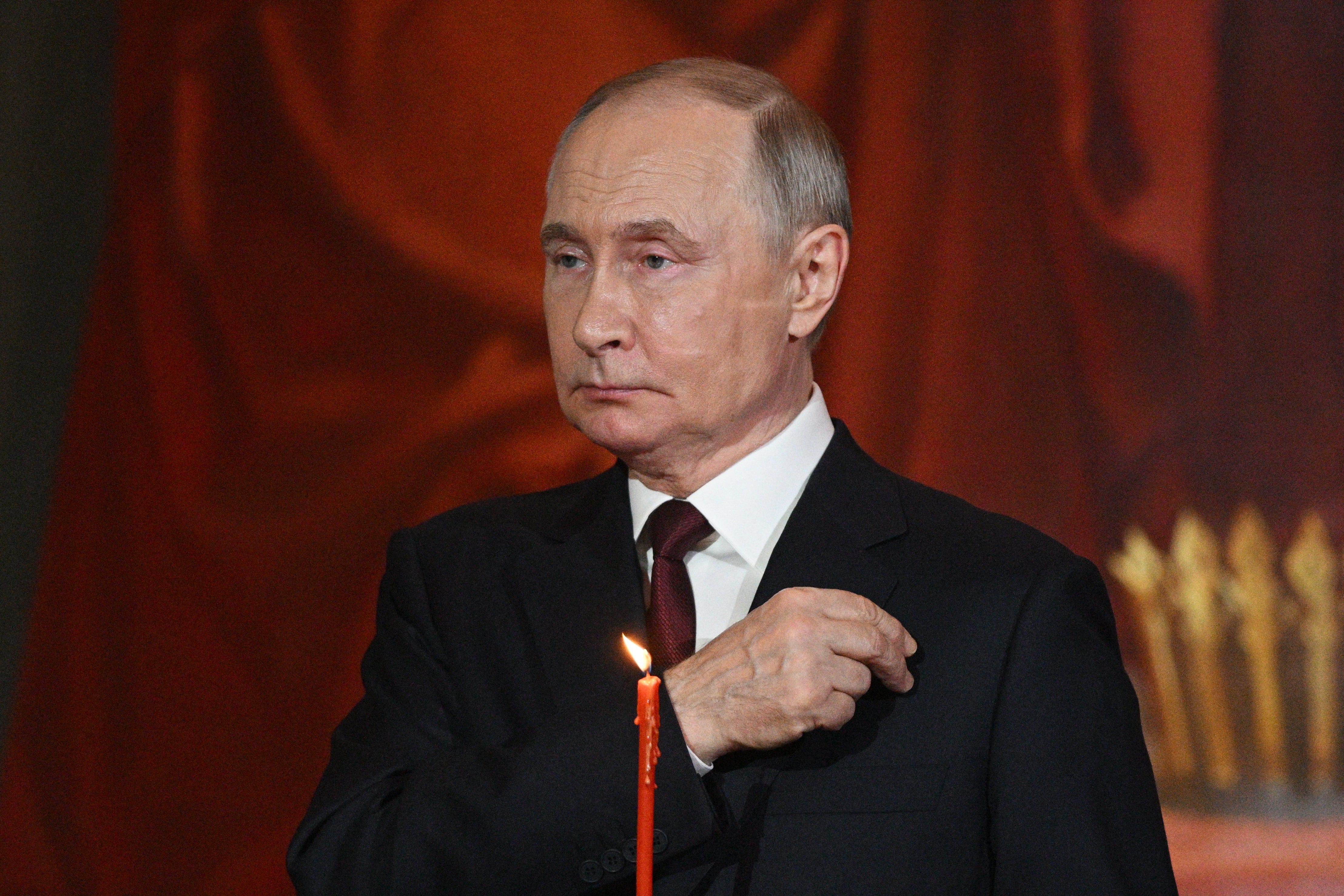 In this pool photograph distributed by Russian state agency Sputnik, Russia's President Vladimir Putin attends an Orthodox Easter service at the Christ the Saviour Cathedral in Moscow early on April 20, 2025. (Photo by Ramil SITDIKOV / POOL / AFP) (Photo by RAMIL SITDIKOV/POOL/AFP via Getty Images)