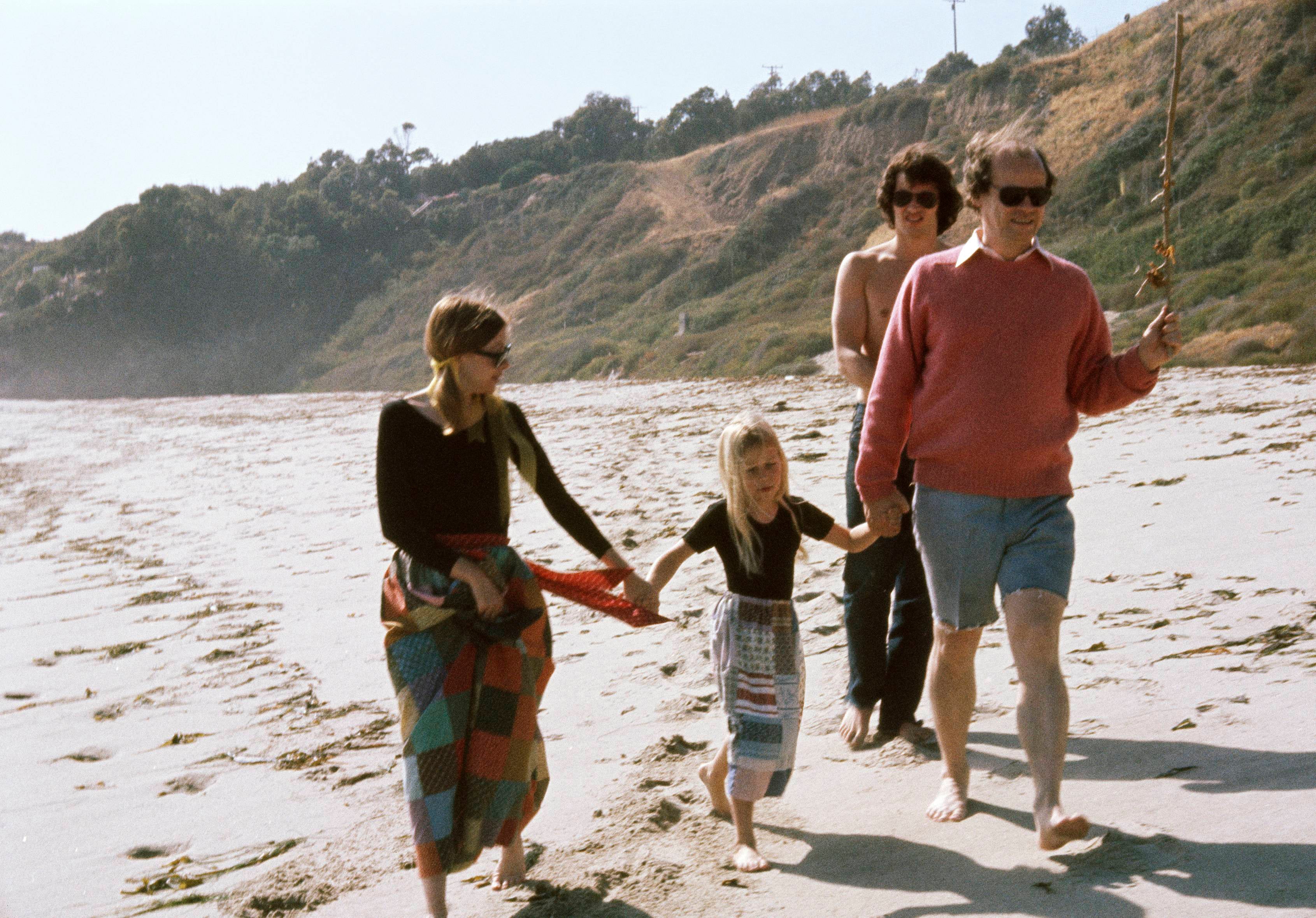 Didion, her husband John Gregory Dunne and their daughter Quintana Roo walk along a Malibu beach