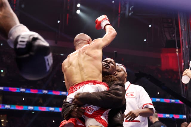 <p>Chris Eubank Sr hoists his son aloft after Jr beat Conor Benn</p>