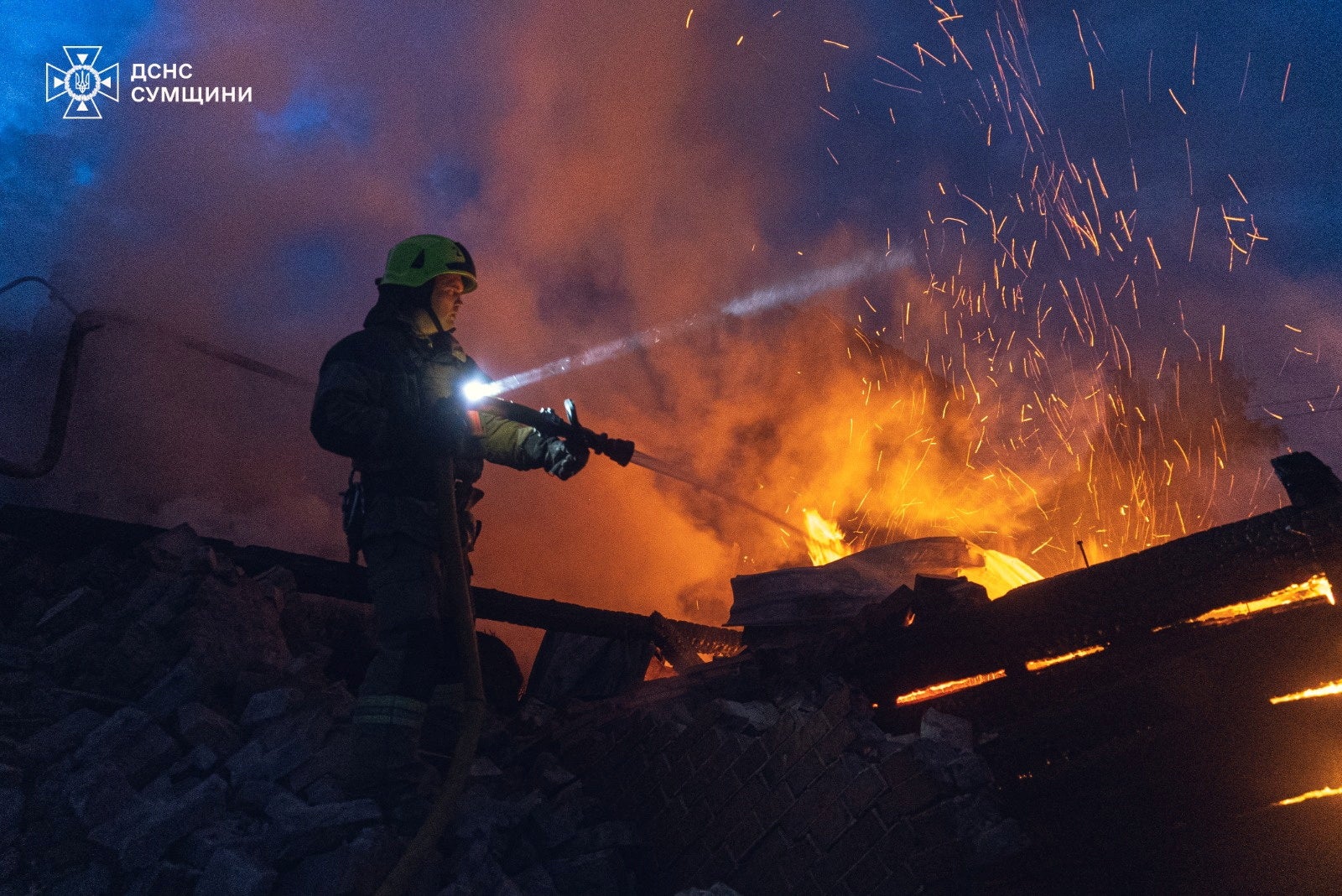 A firefighter works at the site of a Russian drone strike in Sumy region of Ukraine on 29 May 2025