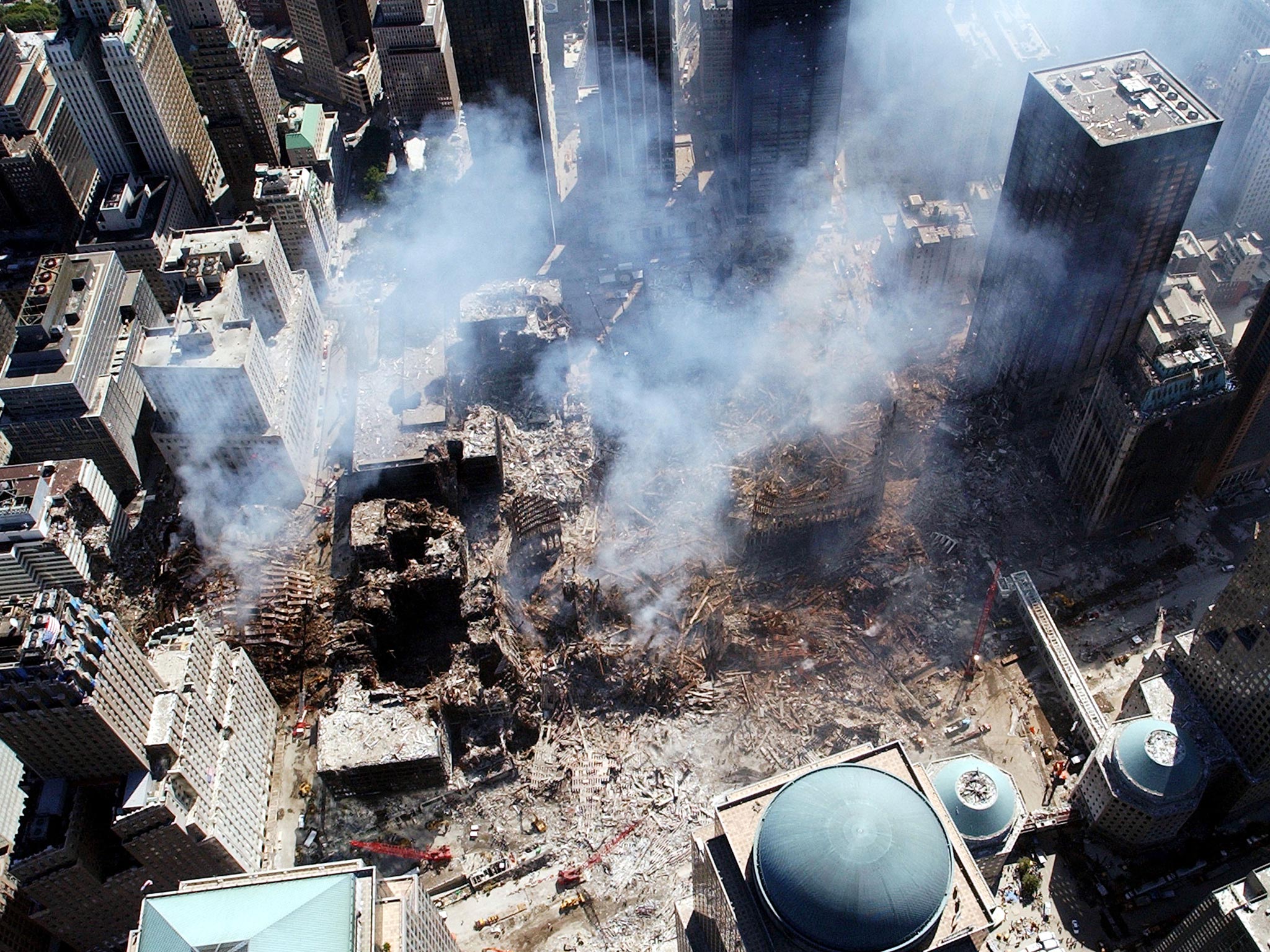 September 2001: An aerial view shows only a small portion of the crime scene where the World Trade Center collapsed following the September 11, 2001 terrorist attack in New York City. Surrounding buildings were heavily damaged by the debris and massive fo